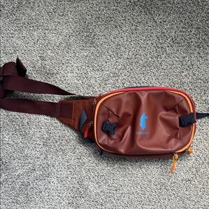 cotopaxi Brown Sling Bag with Blue Logo and Orange Trim